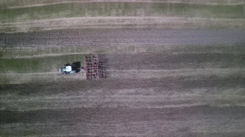 Tractor working on the field doing tillage with cultivator