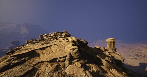 Rocky Landscape Under Clear Blue Sky Featuring Unique Geological Formations