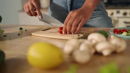 Person Prepares Salad in Kitchen