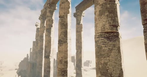 Ruins of Ancient Columns Stand Against a Cloudy Sky in Desert Landscape