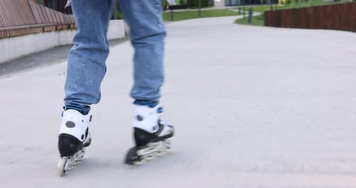 Teen rolling on skates in a park