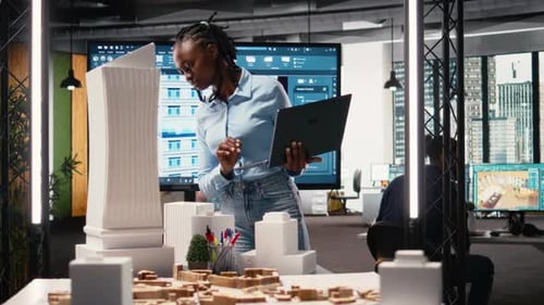African American Female Evaluating 3D Building Model for Measurements