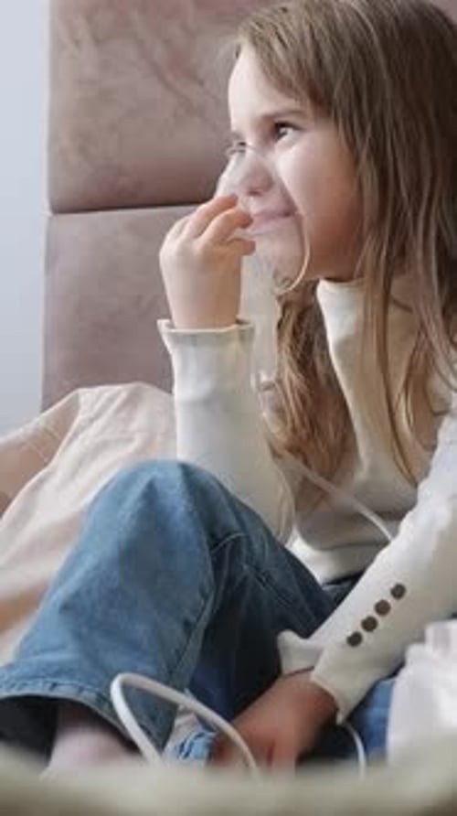 Sick Child Breathing with an Oxygen Mask