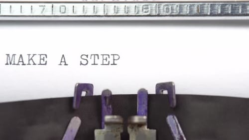 Make A Step phrase closeup being typing and centered on a sheet of paper on old vintage typewriter