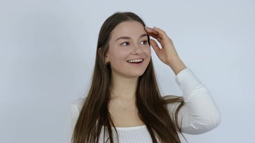 Smiling Woman Posing in a White Studio