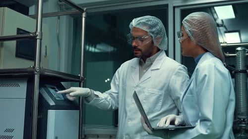 Two Scientist in Professional Uniform Working in Curative Laboratory