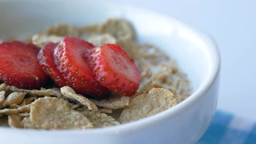 Breakfast Cereal with Fresh Strawberries in White Bowl