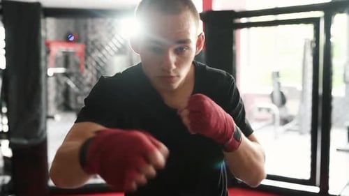 Close view of boxer practicing indoors at gym at daytime
