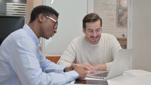 Excited Business People Celebrating Success in Office