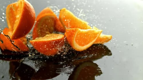 Orange Slices Fall on a Wet Surface Filmed on a Highspeed Camera at 1000 Fps
