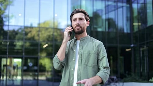 Bearded Man Talking on Smartphone in City