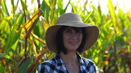 Happy Smiling Female Farmer Looks Into Camera Standing Near Corn Field Portrait of Adult Beautiful