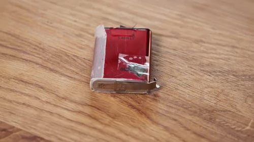 Disassembled Cell Phone Battery Close Up on Wood