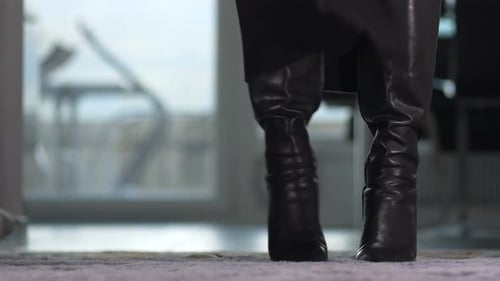 Woman Posing in Shiny Black High-Heeled Boots