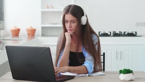 Young Woman Working on Laptop at Home