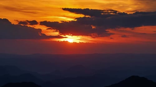 Vibrant Sunrise Sky over Mountainous Horizon
