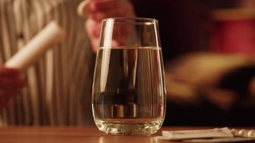 Effervescent Tablet Dissolving in Glass of Water