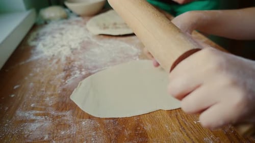 Child Rolls Dough With Wooden Rolling Pin