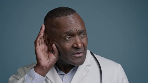 Closeup Confused Puzzled African American Man Male Doctor in Studio Blue Background Holding Hand