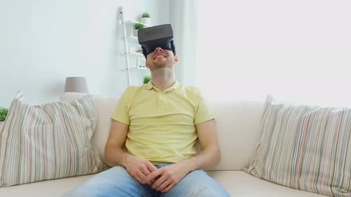 Man Smiling and Wearing VR Headset on Couch