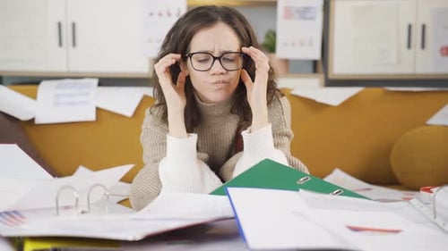 Stressed Woman Overwhelmed by Documents and Folders
