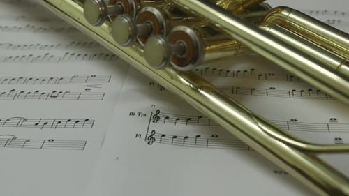 Close Up of Golden Trumpet on Sheet Music