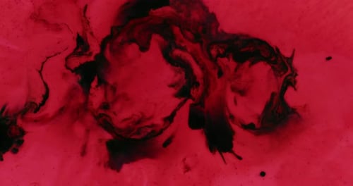 Red Liquid with Dark Swirling Spots in Center