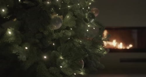 Festive Christmas Tree by Cozy Fireplace at Night