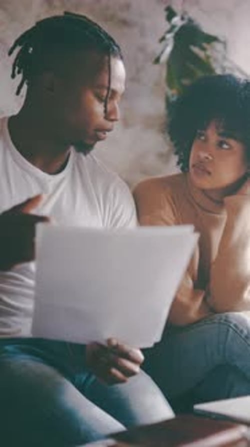 Couple Looking at Documents Inside of Their Home