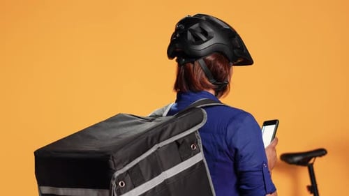 Delivery Person with Helmet Using Mobile Device