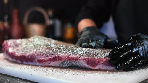 Adult Seasoning Raw Meat with Salt and Pepper