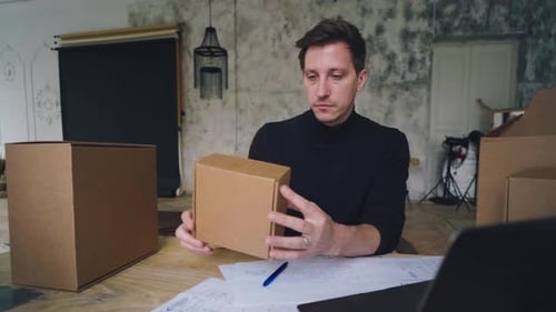 Packaging Design a Man Develops a Box Design Using a Computer and a Sketch