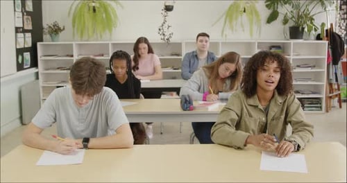 Students Learning in School Class Room. High School or College Class Raising Hand Asking Questions