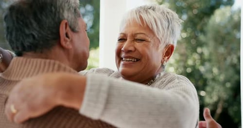 Senior Woman Embracing Man Affectionately Outdoors
