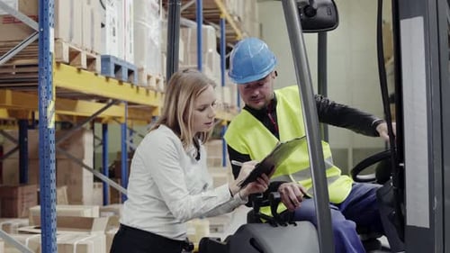 Young Warehouse Workers Working Together