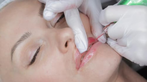 Lip Tattooing Procedure in Action Beautician Applies Pigment Using Sterile Tool Closeup of Permanent