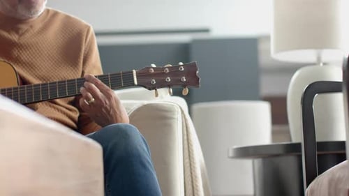Man Plays Guitar in Living Room, Indoors