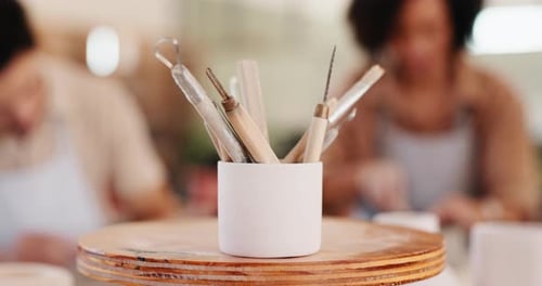 Pottery, art and cup of tools in workshop for artistic process, sculpture design