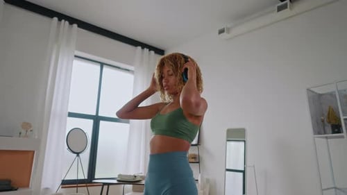 Woman Dancing Freely in Modern Living Room