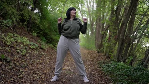 Woman Dances in a Leafy Green Forest