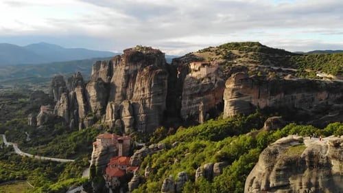 Beautiful shot of a monastery built on a rock. Drone flight during sunset.