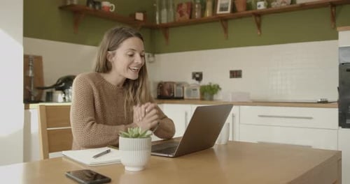 Woman Video Calling, Writing in Notebook in Kitchen