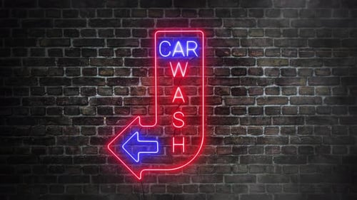 Car wash neon signboard flickering on bricks wall background. Arrow to the left.
