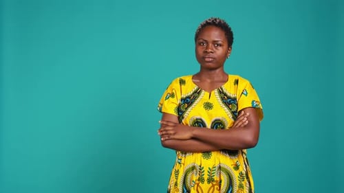 Smiling Woman Poses with Arms Crossed in Studio