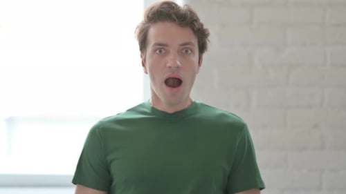 Shocked Young Adult Male with Hand on Chest