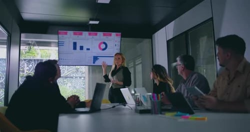 Corporate Team Meeting Presentation in Modern Office