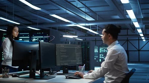 Team of Programmers in High Tech Data Center Troubleshooting Issues