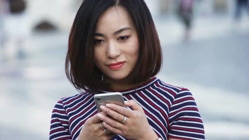 Woman Using Smartphone in Urban Environment