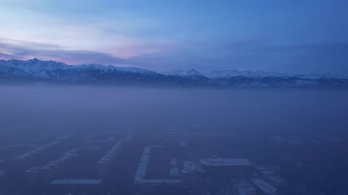 Dawn Over the City in Fog and Smog