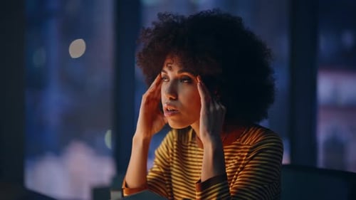 Tensed Entrepreneur Touching Temples at Dark Corporate Workplace Closeup